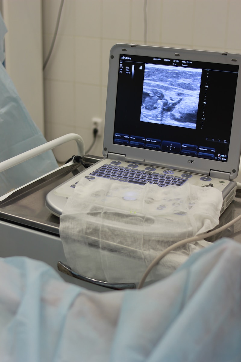 a laptop computer sitting on top of a hospital bed